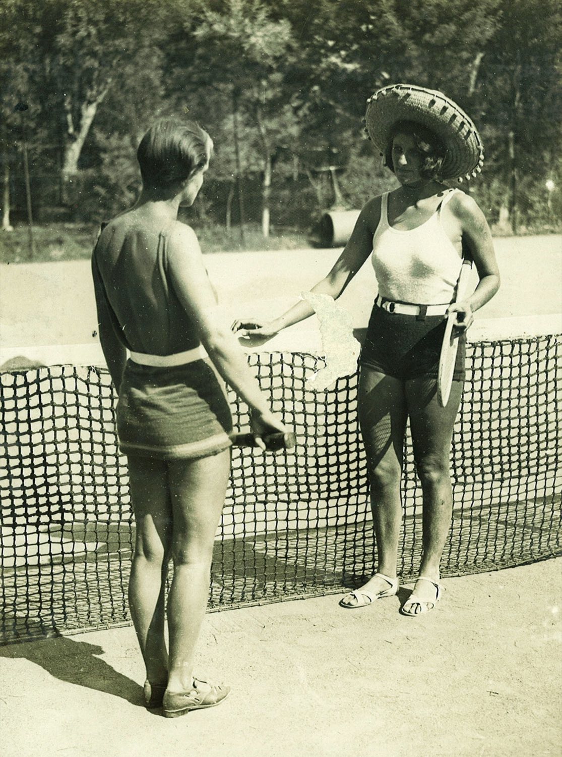 Two players at the net on the clay courts at Hotel du Cap-Eden-Roc in 1927